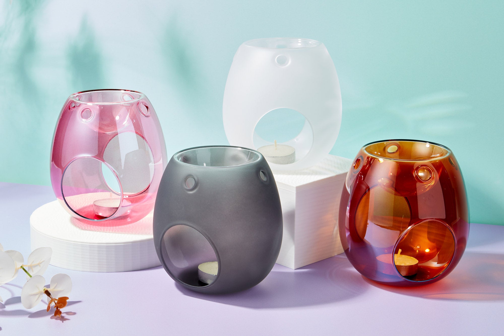 4 Glass wax burners for use with tea lights and wax melts, in warm amber, rose pink, frosted white and frosted black