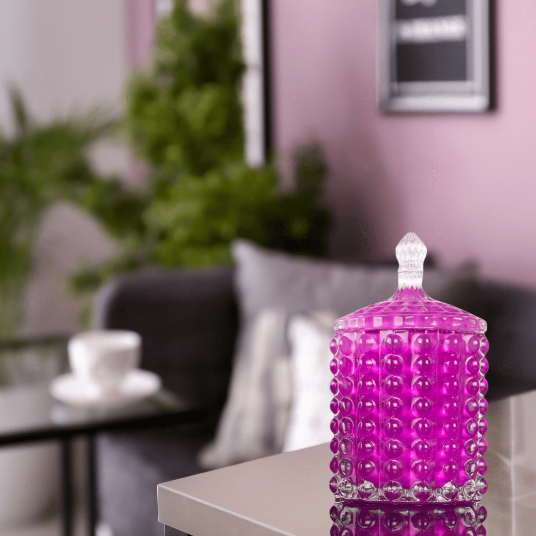 scented candle in a variety of fragrances in a purple glass container, textured with bubbles on the exterior and topped with a beautiful glass lid.