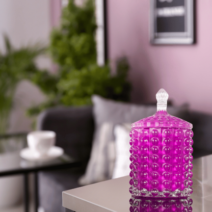 Scented candle in pink glass with bubbles in living room